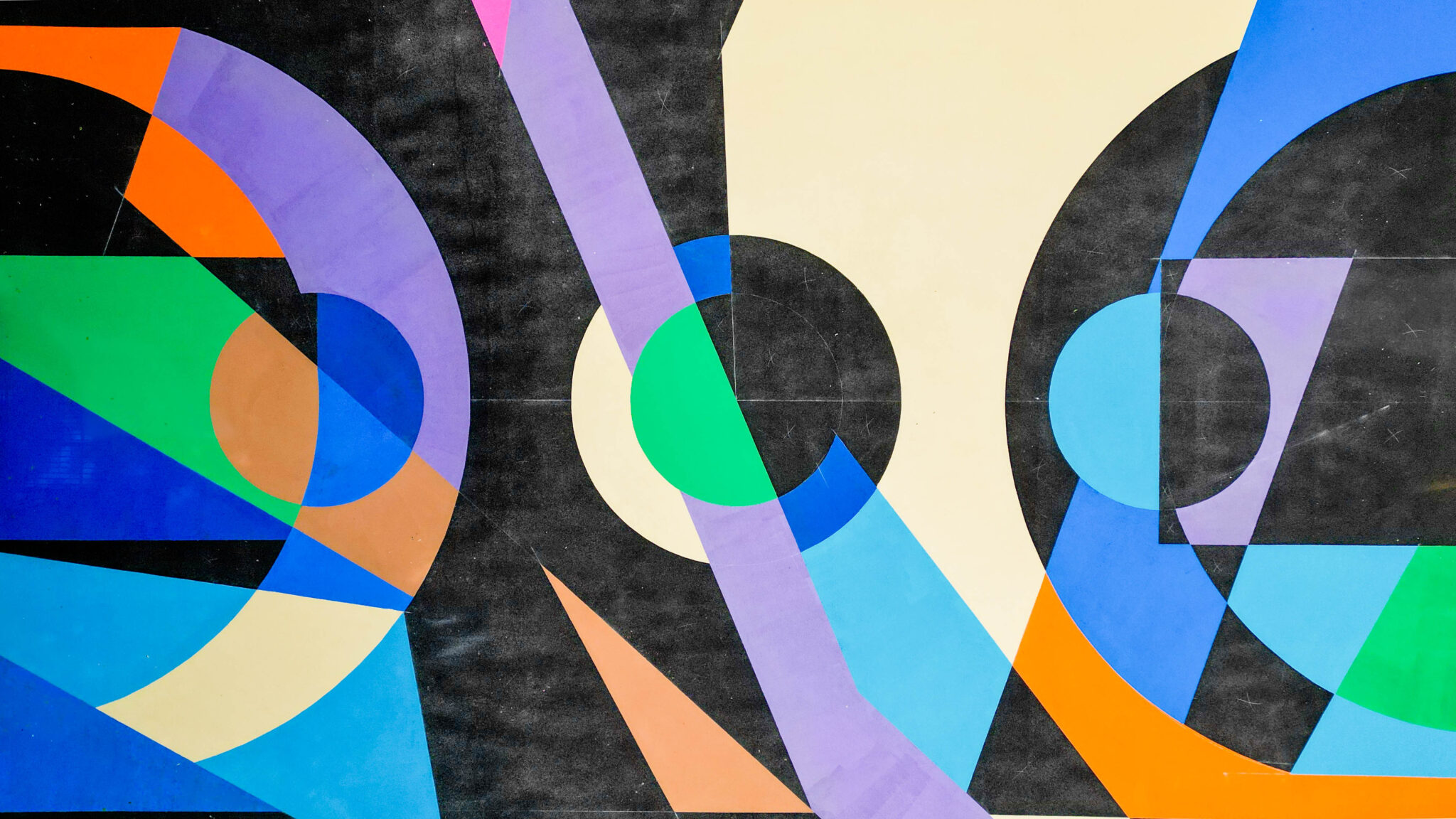 Close-up of the Diamond Park court artwork, with purple, orange, green, cream and blue arcs and circles on black
