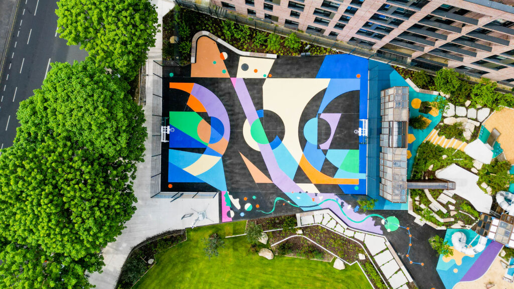 Overhead view of the Diamond Park basketball court in Dublin, painted with abstract shapes in blue, purple, orange and cream