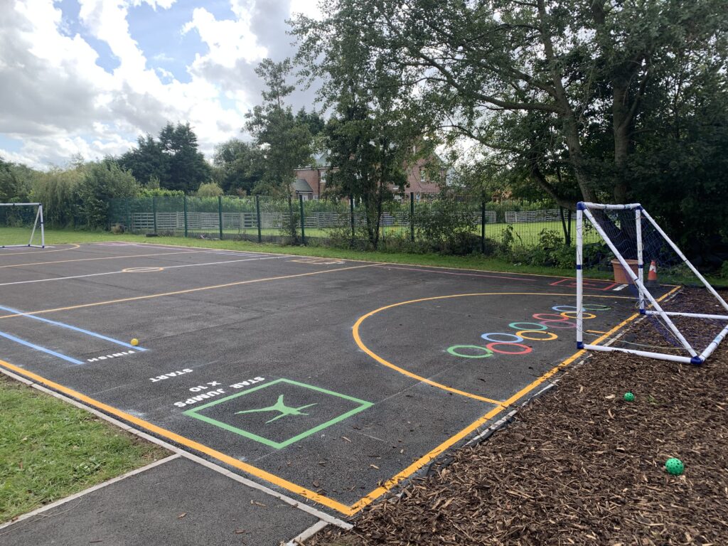 Banks Methodist Primary School court markings with orange lines, coloured hopping rings, a star jumps box and blue sprint lanes