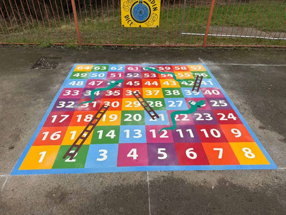1 to 64 Snakes and Ladders thermoplastic playground marking at a UK school