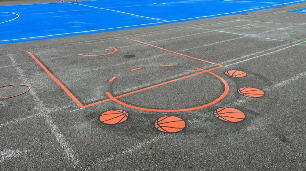 Basketball Court key in orange with orange basketball spots next to a blue painted court