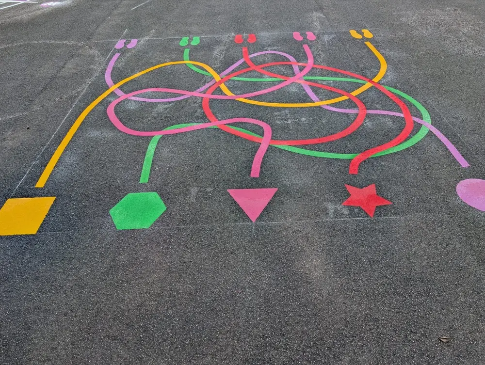Tangled multicoloured Line Maze marking with shape endpoints on a grey school playground