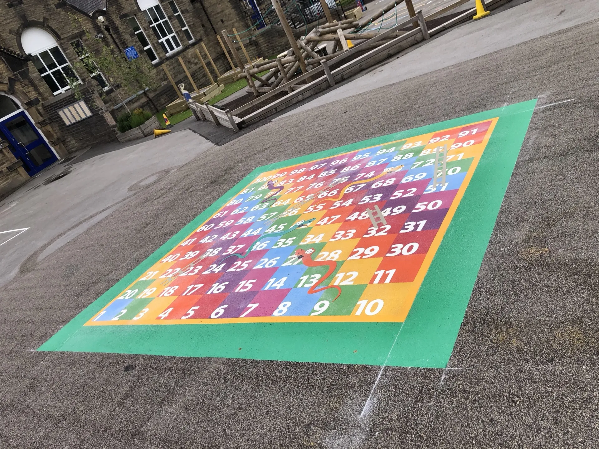 A 1 to 100 number grid thermoplastic marking on a school playground