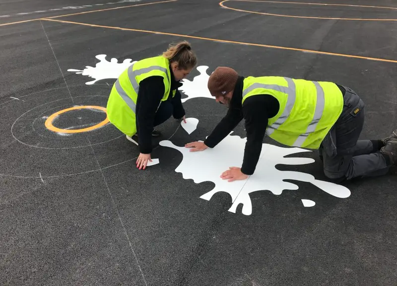 Colourful thermoplastic playground markings across a primary school playground