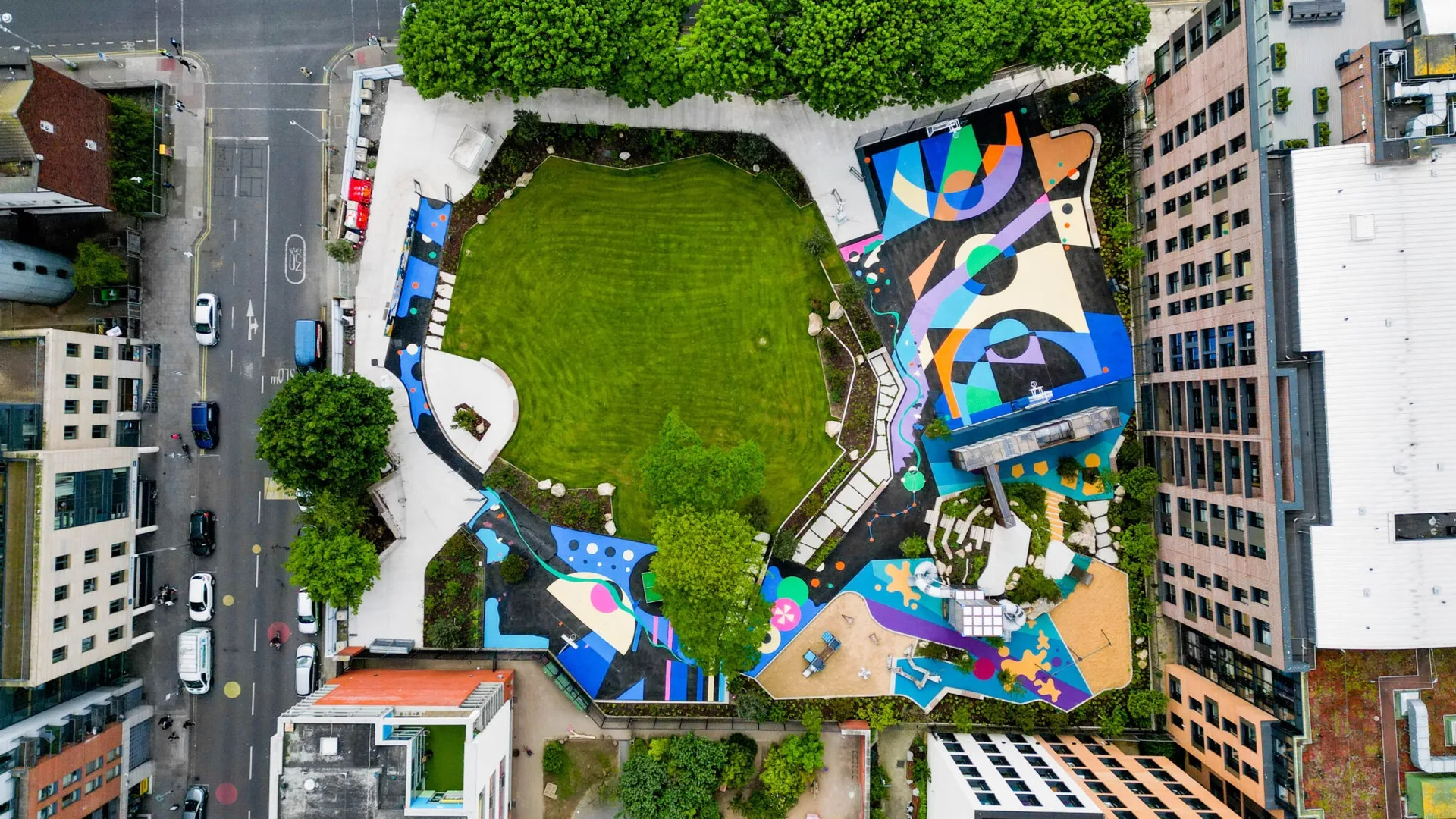 Aerial view of a colourful themed play space with bespoke surface artwork