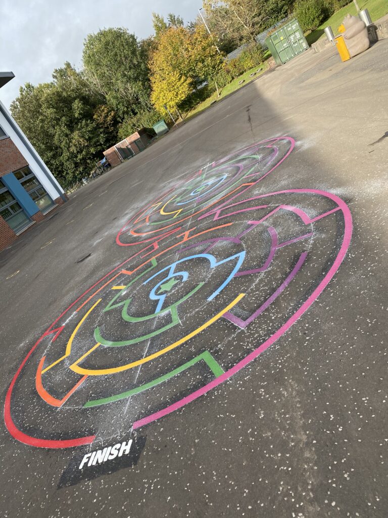 Winding maze markings painted across a school playground