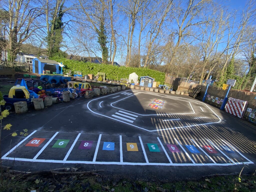 Mini roadway with zebra crossing and parking bays for road safety