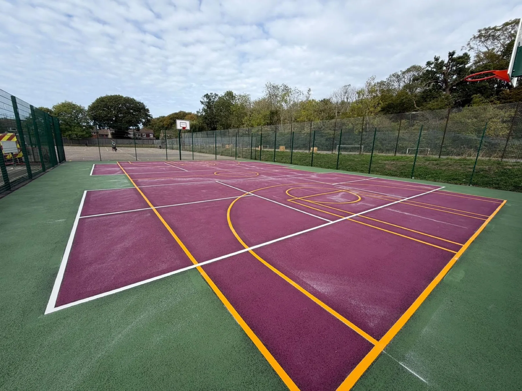 Bright purple full-colour surface with yellow and white court line markings